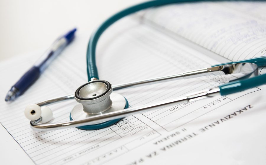 A stethoscope resting on a patient chart